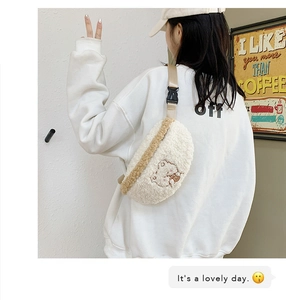Detailed close-up of cute white plush crossbody bag with cartoon bear embroidery
