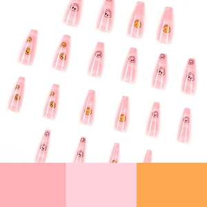 Long coffin press-on nails in translucent pink with vibrant colorful smiley face patterns