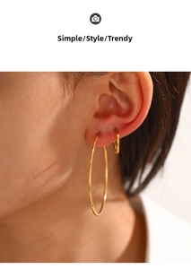 Detailed close-up of gold hoop earrings for women showing a stylish stacked wearing look