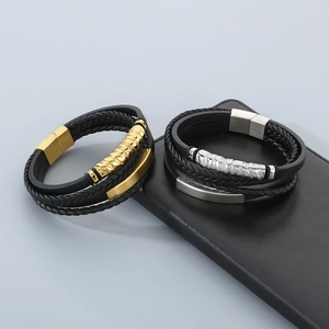 Detail of multi-layer braided leather bracelet with gold and silver magnetic metal clasps