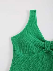 Détail macro du tissu froissé vert vif du maillot de bain avec texture ondulée