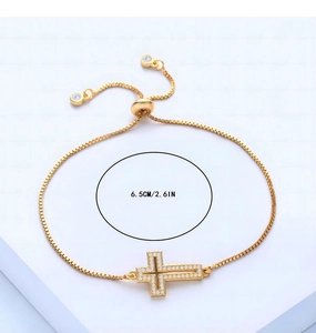 Detail view of gold cross bracelet showing the 6.5cm adjustable sliding buckle closure