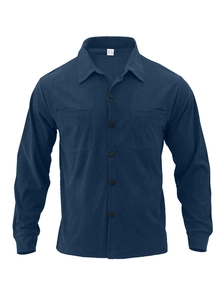 Detail of navy blue corduroy jacket with chest pockets and white cotton size label