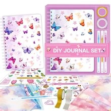 Close-up of DIY journal set with purple butterfly notebook, stickers, and washi tape