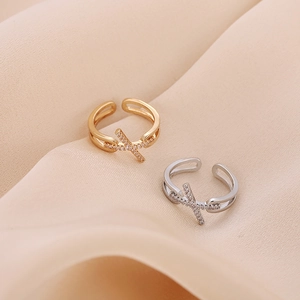 Adjustable cross-over copper rings with zircon stones in gold and silver finishes