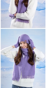 Close-up of purple knit winter set showing rib-knit hat with leather label and tassels