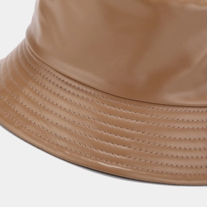 Detail of parallel stitching and leather texture on a brown PU bucket hat