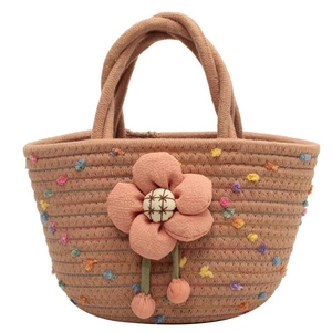 Handmade woven cotton rope handbag with colorful pom-poms and large decorative flower