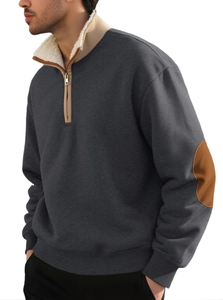Detailed macro view of the dark grey sweatshirt showing brown elbow patches and fleece lining