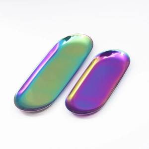 Macro shot of two oval stainless steel trays with rainbow iridescent plating