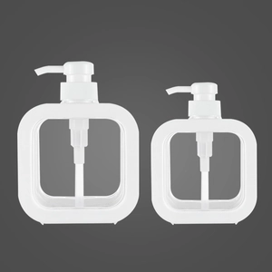 Close-up of two transparent square refillable bottles with white pumps in different sizes