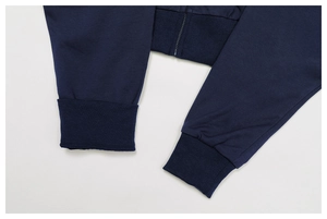 Close-up of navy blue zip-up hoodie featuring high-density knit fabric and ribbed cuffs