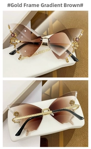 Detail of butterfly sunglasses with gold frames, colorful rhinestones and gradient lenses