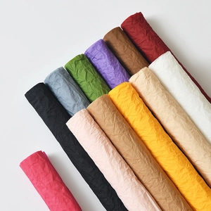 Premium crinkled flower wrapping paper in various vibrant colors for professional floral design