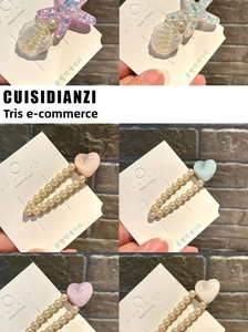 Detail view of pearl hair clips with colorful starfish and seashell charms in a set