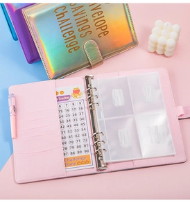 Close-up of holographic 100 day envelope savings challenge binder with budget tracker card