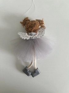 Detail of Christmas angel pendant with grey mesh skirt and silver wings on white background