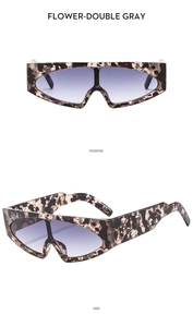 Detail view of wide frame tortoise shell sunglasses with purple gradient lenses