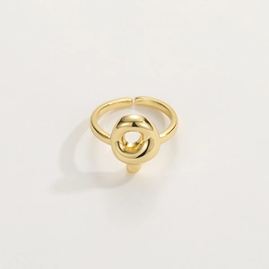 Close-up of polished 18K gold letter ring featuring an adjustable open design and glossy finish