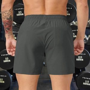 Detail view of dark grey athletic shorts with elastic waistband from a back perspective