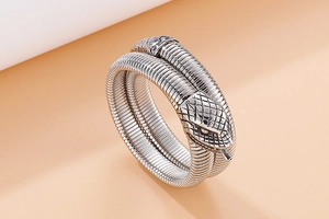 Detail shot of silver cobra snake wrap bracelet showing intricate scale texture and carving