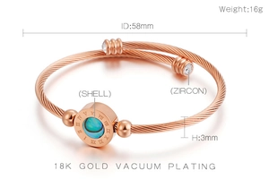 Detail of rose gold bangle with shell inlay, roman numerals, and zircon stones specs
