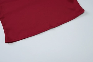 Detail of burgundy backless crop top showing high-quality hem stitching and fabric texture