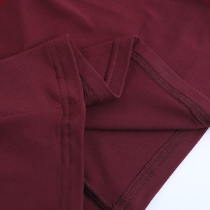 Close-up of wine red knitted fabric with meticulous stitching and seam details