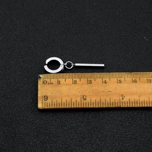 Detailed view of silver titanium tassel earring with ruler showing 4cm length measurements