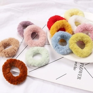 Close-up of soft colorful plush scrunchies in various vibrant Morandi shades