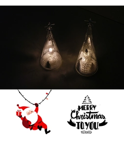 Detail of clear Christmas tree LED lights with etched white patterns and warm yellow glow