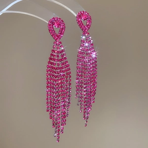 Detailed view of rose red rhinestone tassel earrings with a brilliant sparkling effect