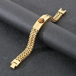 Detailed close-up of tiger eye stone and zircons on gold-plated stainless steel men's bracelet