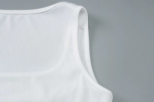 Detail of white ribbed knit fabric featuring high-quality U-neck stitching and binding
