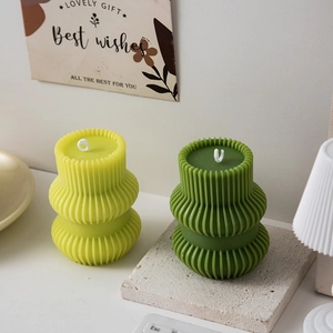 Modern ribbed pillar scented candles in light and dark green for home decor aesthetics