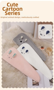 Detailed view of pink, white, and grey coral fleece hair drying hats with cute bunny ears