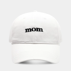 Detailed close-up of 'mom' embroidery on a premium white cotton twill baseball cap