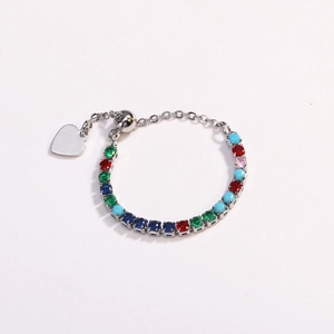 Detail of adjustable silver bracelet with multi-colored round zircons and heart charm