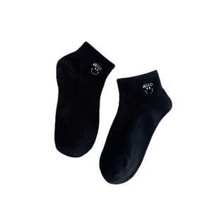 Women's black cotton low-cut socks with white HELLO embroidery and smiley face pattern