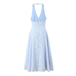 Detail showing light blue floral lace texture and backless halter neck design on dress