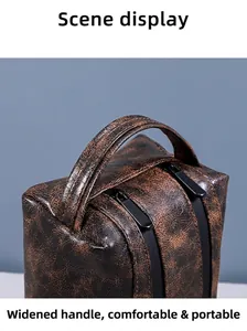 Close-up of vintage brown PU leather toiletry bag with widened handle and dual zippers