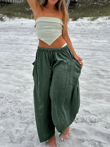 Close-up of deep green cotton linen wide-leg pants with elastic drawstring waist details