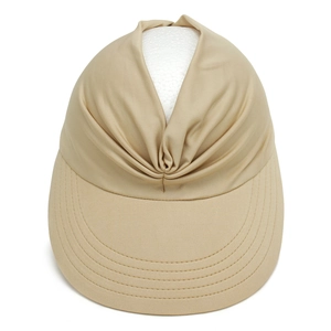 Macro view of the elegant twisted fabric design on a women's khaki sun visor hat