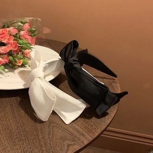 Elegant double-layered satin bow headbands in black and white colors for women