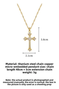 Detail shot of a luxury gold cross pendant featuring sparkling white zircon inlay work