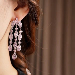Detail of silver drop tassel earrings with pink marquise and pear-shaped cubic zirconia