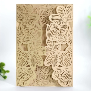 Detail of laser-cut floral pattern on champagne gold engagement invitation card