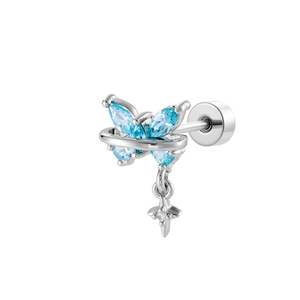 Silver butterfly earring with blue stones and a dangling cross pendant on white background