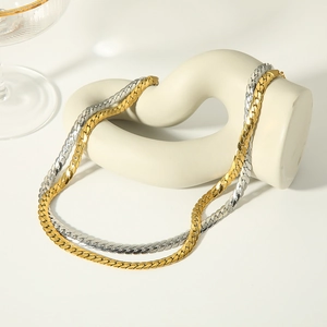 Elegant 18k gold and silver titanium steel Cuban link chain necklaces on art stand
