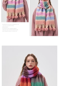 Detail of colorful striped scarf with soft pom-pom tassels and thick mohair texture